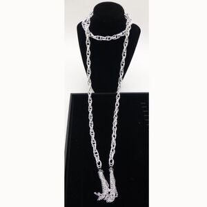 New In Package. Necklace and Earring Set: Silver-Tone Open Ended Tassel Necklace